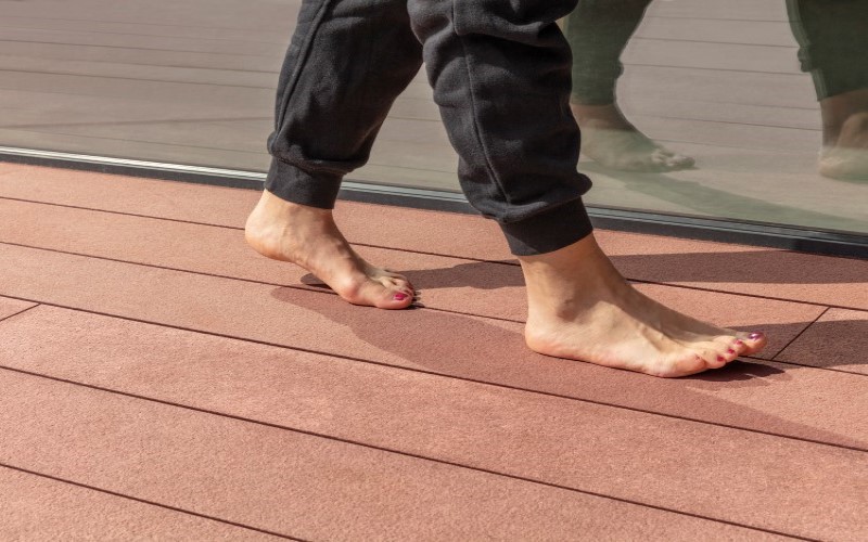 a person standing bare feet on an orange floor