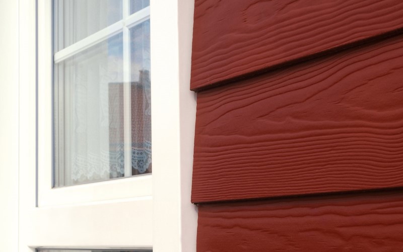 on the left white window and on the right dark red weatherboard