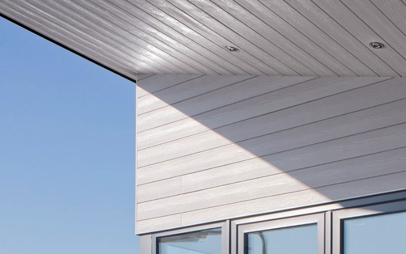 white facade weatherboards light blue sky