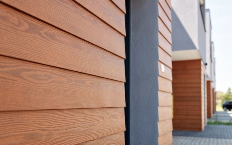 orange Cedral weatherboard siding with grey stripes