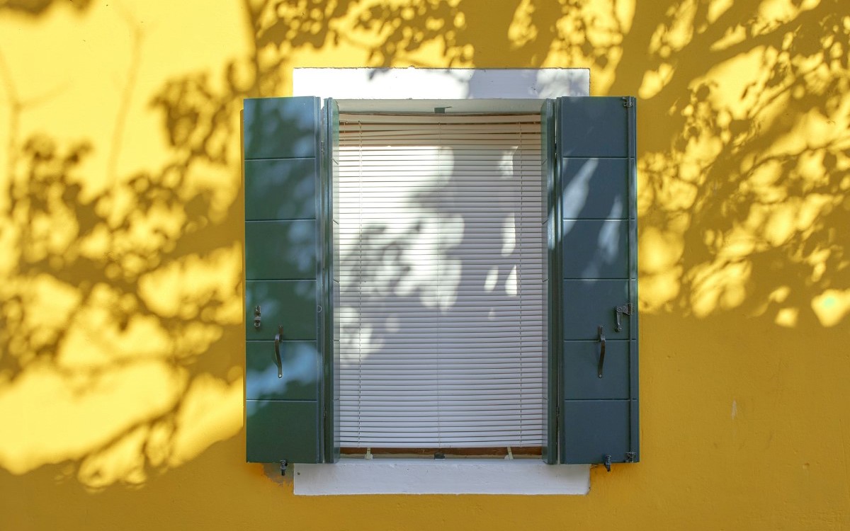 Close your house as much as possible when the sun is out. Close shutters, curtains and doors, and open them again for fresh air when it has cooled down.
