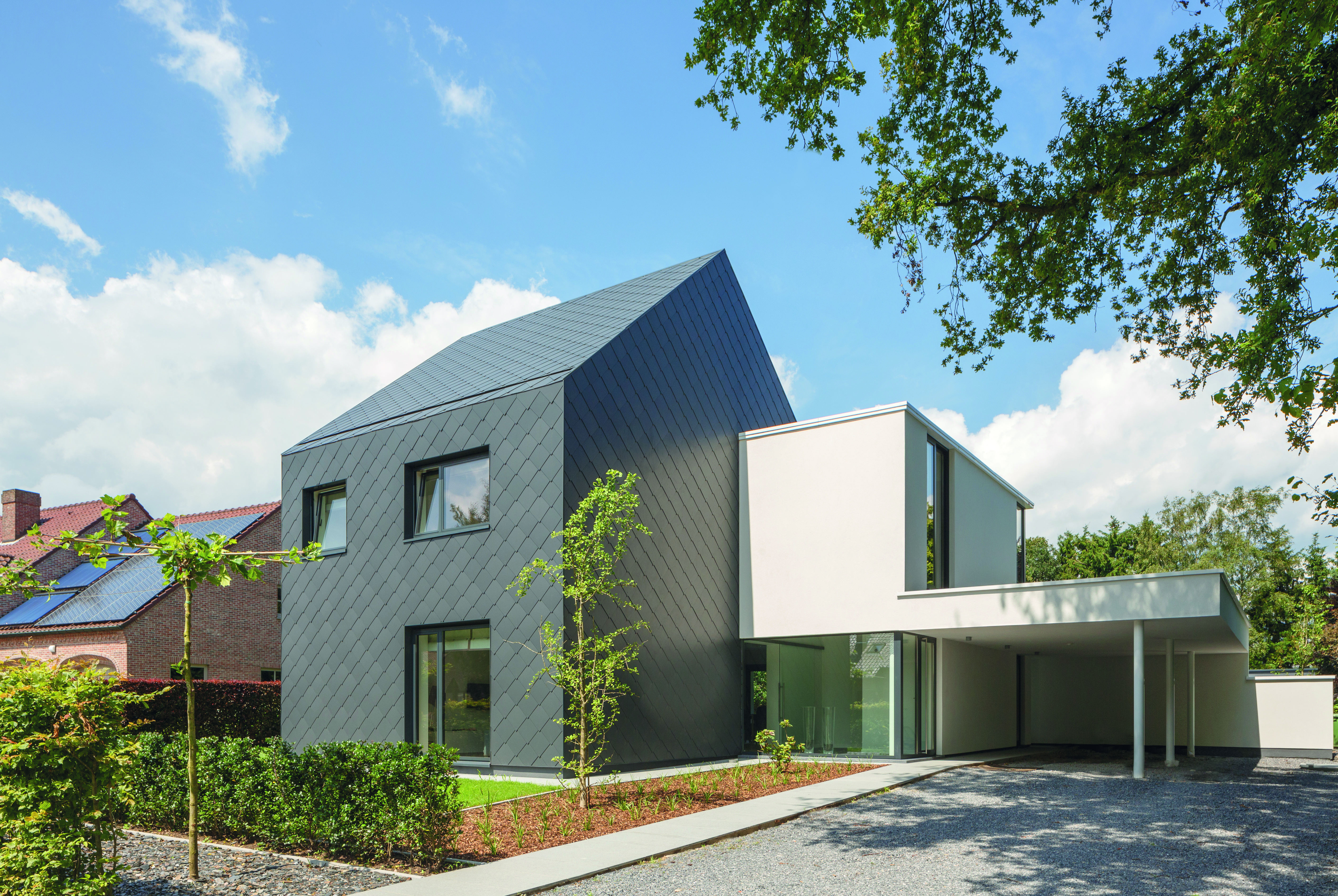 Modern home clad in Cedral fibre cement slates used for both façade and roof, offering seamless, durable full-envelope design.