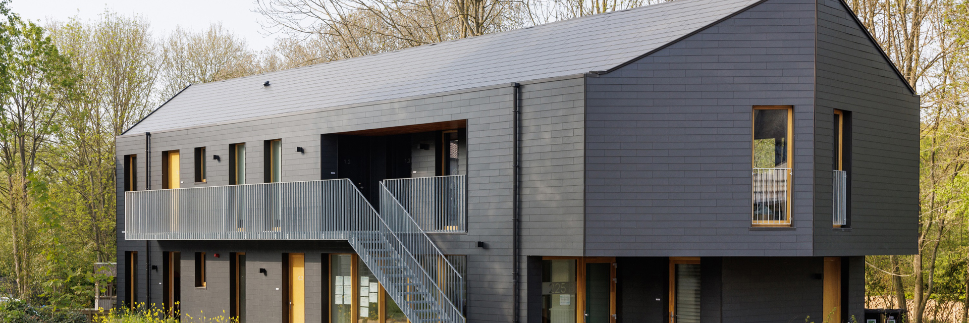 Modern building clad in Cedral slates (Thrutone Smooth Blue Black) in double pattern for roof and façade with seamless design.
