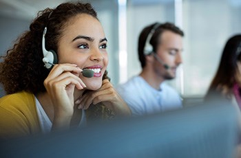 Smiling customer service agent wearing a headset, ready to assist Cedral Canada inquiries via contact form.
