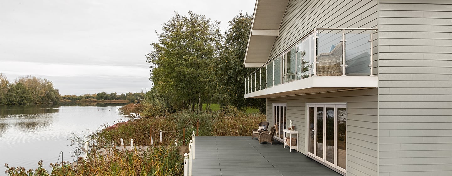 Woning aan het water met beige Cedral gevelbekleding