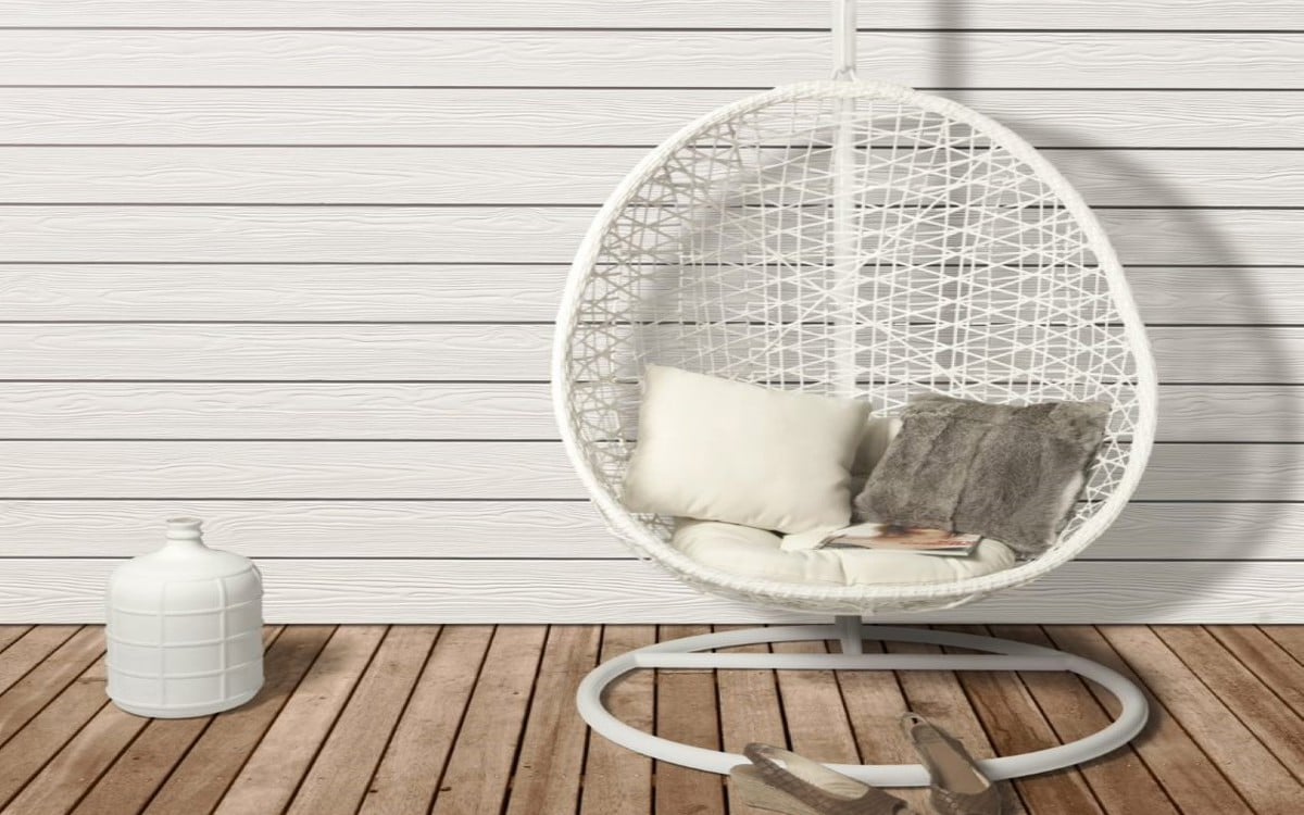 white wall sidings and white armchair the ground is wooden